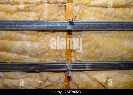 Aluminum frame with hangers placed on beams in the attic for mounting plasterboards. Stock Photo