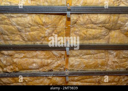 Aluminum frame with hangers placed on beams in the attic for mounting plasterboards. Stock Photo