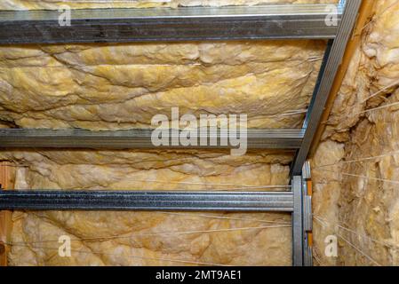 Aluminum frame with hangers placed on beams in the attic for mounting plasterboards. Stock Photo