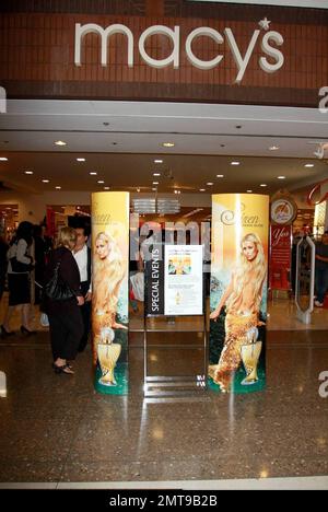 Paris Hilton dons a Mrs. Claus dress at a promotion for her fragrance Siren at Macy's. Paris greeted and took photos with fans during the event while boyfriend Doug Reinhardt watched from the sidelines. Glendale, CA. 12/3/09. Stock Photo