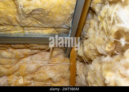 Aluminum frame with hangers placed on beams in the attic for mounting plasterboards. Stock Photo