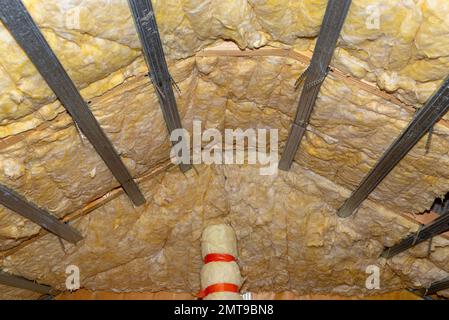 Aluminum frame with hangers placed on beams in the attic for mounting plasterboards. Stock Photo