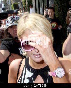 Paris Hilton primps herself during a shopping trip to Diane von Furstenberg's boutique. She sprayed herself with perfume, touched up her lipstick and spent a while checking out her reflection in the mirror. Paris also paid a visit to Marc Jacobs and Fred Segal. Paris was carrying one of her own handbags emblazoned with her name. Los Angeles, Ca. 3/13/08. Stock Photo