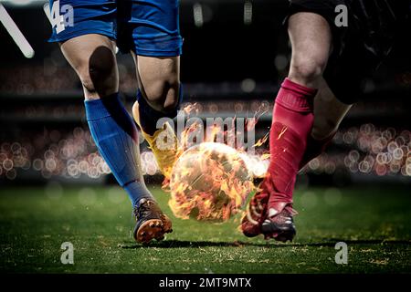 CG image of soccer players hitting the ball with fire Stock Photo