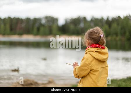 Little girl jumping on trampoline and going down the slide Stock Photo