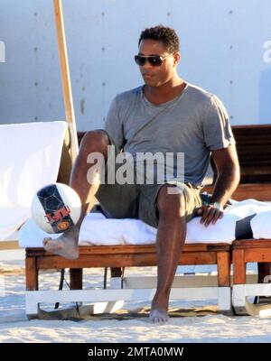 Patrick Kluivert, former Dutch footballer and current NEC Nijmegen Assistant Coach, enjoys a day on the beach playing soccer with his wife, Rossana Lima and his son, Shane Patrick, during a winter holiday in Miami Beach, FL. 1/5/11. Stock Photo