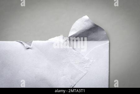 Torn (opened) envelope on a grey background Stock Photo