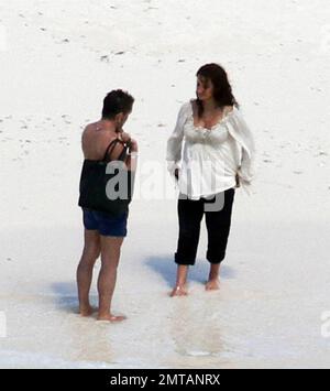 EXCLUSIVE!! Penelope Cruz is seen barefoot on a deserted island beach