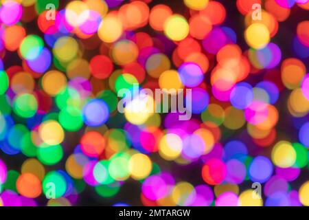 Multi-colored blurred circles of light on a dark background with bokeh effect Stock Photo