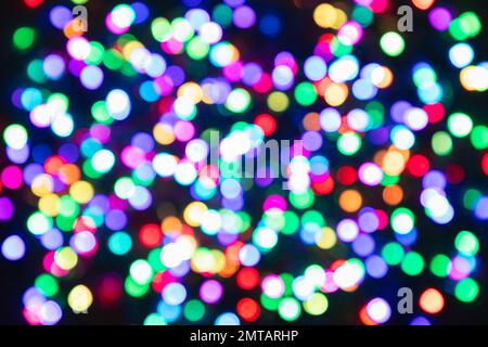 Blurred multi-colored light bulbs on a black background, bokeh effect Stock Photo