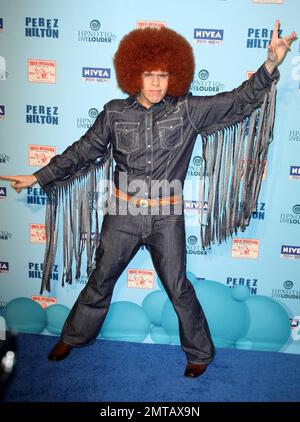 Dressed in a wacky fringe denim outfit and a big afro wig celebrity blogger Perez Hilton arrives at his Blue Ball Birthday Celebration and blue themed dress up party held at Siren Studios