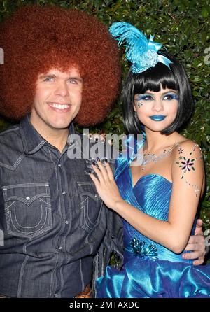 Dressed in a wacky fringe denim outfit and a big afro wig