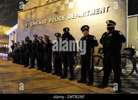 FILE - In this Nov. 24, 2015, file photo, Chicago police officers line up outside the District 1 central headquarters in Chicago, during a protest for the fatal police shooting of 17-year-old Laquan McDonald. Special prosecutor Patricia Brown-Holmes announced Tuesday, June 27, 2017, that three Chicago police officers were indicted on felony charges that they conspired to cover up the actions of Chicago Police Officer Jason Van Dyke in the killing of McDonald. The indictment, approved by a Cook County grand jury, alleges that one current and two former officers lied about the events of Oct. 20,