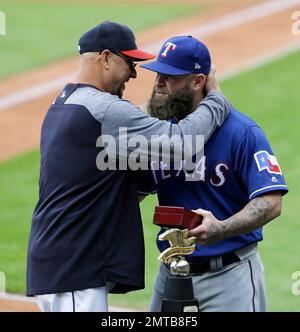 Texas Rangers Mike Napoli removes his gloves after striking out in