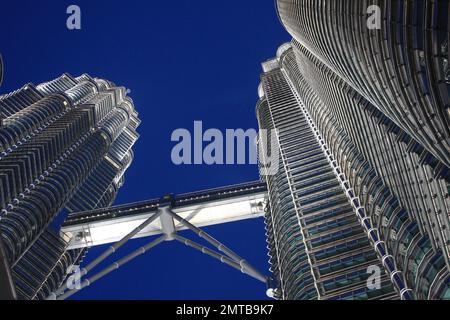 An ant's eye view of Petronas Towers and it's skybridge at night in Kuala Lumpur, Malaysia. Stock Photo