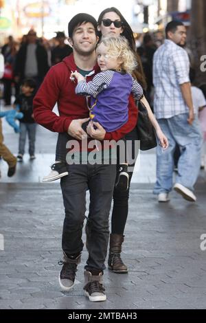 'Fallout Boy' rocker Pete Wentz takes his son Bronx and model girlfriend Meagan Camper to see a movie at Universal City Walk. Pete, in a green t-shirt, red sweatshirt, black pants and grey sneakers, was seen carrying 2 year old Bronx while Meagan dressed in all black from head to toe followed close behind. Los Angeles, CA. 10th December 2011. Stock Photo