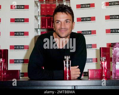 After a quick shirt change and half hour drive, singer and reality TV star Peter Andre appears at The Perfume Shop in Elms Shopping Centre in High Wycombe for an autograph session, launching his new fragrance for women, Mysterious Girl.  Earlier in the day Peter attended a photo call at The Chimes Shopping Centre in Uxbridge.  And while Peter has been busy maintaining his musical and merchandise career, ex-wife Katie Price appears to have been nurturing her new husband Alex Reid's professional mixed martial arts fighting career; she was seen ringside cheering Alex on last week during his UFC B Stock Photo