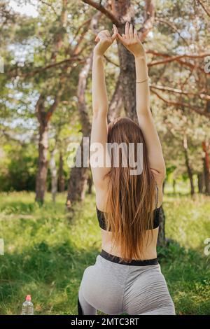 Overweight, obese woman in sports bra and leggings holding her hands on her  fat belly Stock Photo - Alamy
