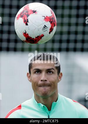 Portugal's Cristiano Ronaldo heads the ball during a team training