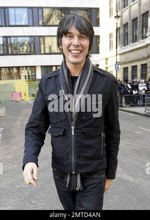 Having begun his career as a rock star in 1986 when his band Dare signed with A&M Records, Professor Brian Cox, now a particle physicist, is all smiles as he leaves the BBC. London, UK. 3/4/11. Stock Photo