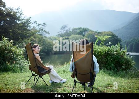 Young Japanese couple at campsite Stock Photo
