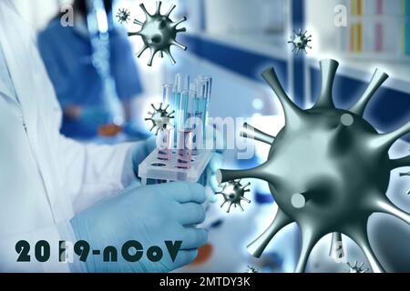 Scientist holding test tubes with liquids in laboratory. Researching of coronavirus Stock Photo