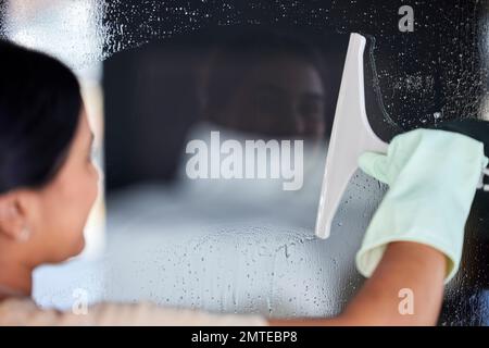 Woman cleaning window, cleaner and chemical for hygiene, surface disinfection and protection from bacteria. Housework, clean service and housekeeper Stock Photo
