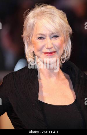 Helen Mirren is unfazed by the rain and is stunning in a flowing black dress with red accents and sparkly heeled boots at the red carpet UK premiere of the action comedy 'Red' held at Royal Festival Hall. London, UK. 10/19/10. Stock Photo