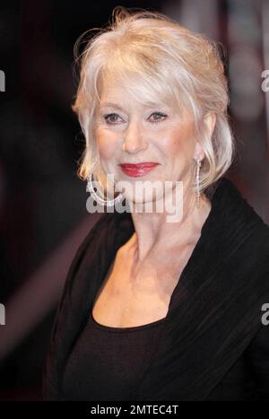 Helen Mirren is unfazed by the rain and is stunning in a flowing black dress with red accents and sparkly heeled boots at the red carpet UK premiere of the action comedy 'Red' held at Royal Festival Hall. London, UK. 10/19/10. Stock Photo