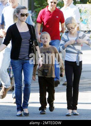 Reese Witherspoon and boyriend Jim Toth hold hands with her kids, daughter Ava and son Deacon in tow ater reportedly attending a Sunday church service.  Reese smiled at Jim as the our, who seem to all get along very well, strolled to a restaurant or lunch beore heading home. Los Angeles, CA. 12/12/10.