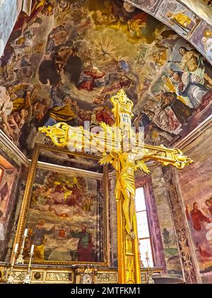 ASCONA, SWITZERLAND - MARCH 28, 2022: St Peter and St Paul Church with golden cross and frescoed altar and apse,  on March 28 in Ascona Stock Photo