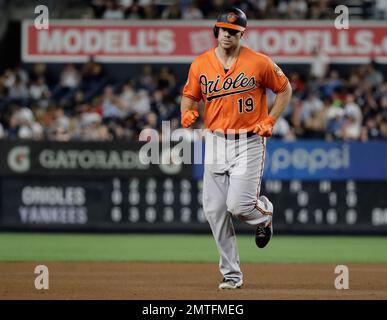 Baltimore Orioles' Chris Davis (19) steps on home plate after hitting a  solo home run against the New York Yankees during the fourth inning of a  baseball game Friday, April 6, 2018