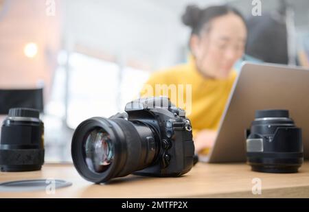 Photography camera, laptop and photographer editing photoshoot, focus on digital art or retouching artistic photo. Studio, creative vision and Stock Photo