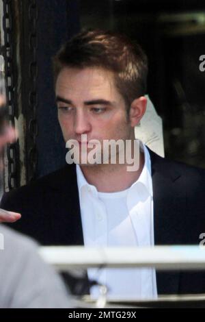 British actor Robert Pattinson was spotted on set location in Los Angeles shooting scenes for his upcoming new film 'Map To The Stars.' It's been reported that 27 year old Pattinson had a very 'intense conversation' with former girlfriend Kristen Stewart during a reunion at her L.A. house on August 4th. According to a source, the on-again-off-again couple will probably pick up where they left off and said, 'Rob is obsessed with her.' One of Stewart's pals stated, 'She's still heartbroken. She can't seem to get over him.' There's a good chance Robert could get his woman back even though they ha Stock Photo