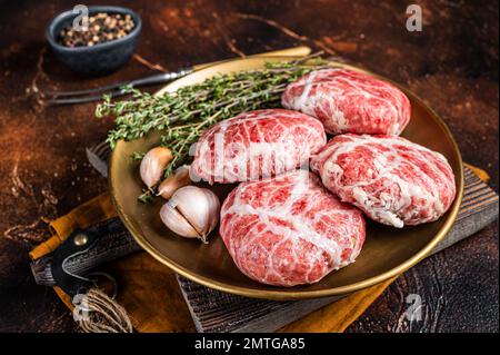 Raw french meatballs cutlet with spices and herbs. Dark background. Top view. Stock Photo