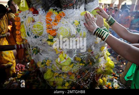 Indian Hindu married women perform rituals as they worship a Banyan ...