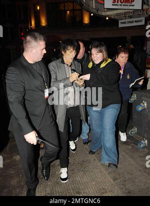 Sucking back on a cigarette and wearing white high-top sneakers The Rolling Stones guitarist Ronnie Wood and girlfriend, Brazilian polo coach Ana Araujo, are flanked by security guards as they arrive at the West End's Ambassadors Theatre for an intimate one-night only concert launching the tribute album Boogie 4 Stu.  The album was created by Ben Waters in memory of the late Ian Stewart (aka Stu), co-founder of The Rolling Stones, who died from a heart attack at the age of 47 in 1985.  Proceeds from the album will go to the British Heart Foundation.  As Ronnie made his way about the outside of Stock Photo