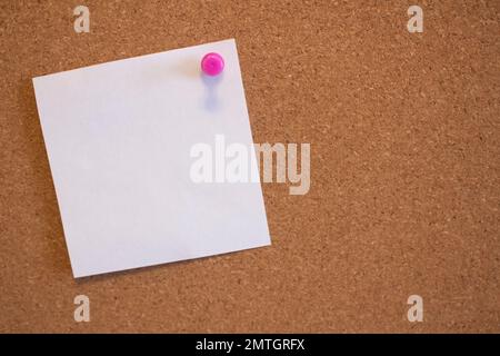 White empty sticker pinned to a cork board in an office Stock Photo