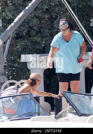 EXCLUSIVE!! Looks like Rosie O'Donnell and girlfriend Tracy Kachtick-Anders may have reconciled after their reported split of Feb 2011. Rosie helped her friend out of a boat and the pair held hands as they walked along a dock after an afternoons boating with two hunky male friends, Miami Beach, FL, 03/23/11. Stock Photo