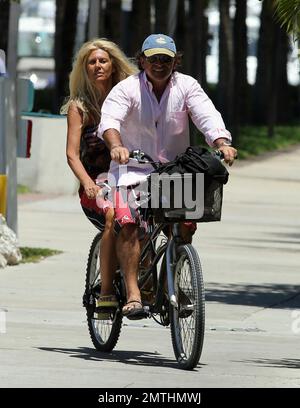 EXCLUSIVE!! Ruta Maria Teresa wears a patriotic stars and stripes bikini and wrap as she strolls and takes a bike ride with husband Roberto Zappulla at the South Beach Marina. Miami Beach, FL. 5th May 2014. Stock Photo