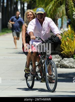 EXCLUSIVE!! Ruta Maria Teresa wears a patriotic stars and stripes bikini and wrap as she strolls and takes a bike ride with husband Roberto Zappulla at the South Beach Marina. Miami Beach, FL. 5th May 2014. Stock Photo