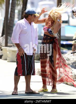 EXCLUSIVE!! Ruta Maria Teresa wears a patriotic stars and stripes bikini and wrap as she strolls and takes a bike ride with husband Roberto Zappulla at the South Beach Marina. Miami Beach, FL. 5th May 2014. Stock Photo