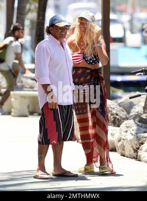 EXCLUSIVE!! Ruta Maria Teresa wears a patriotic stars and stripes bikini and wrap as she strolls and takes a bike ride with husband Roberto Zappulla at the South Beach Marina. Miami Beach, FL. 5th May 2014. Stock Photo