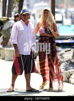 EXCLUSIVE!! Ruta Maria Teresa wears a patriotic stars and stripes bikini and wrap as she strolls and takes a bike ride with husband Roberto Zappulla at the South Beach Marina. Miami Beach, FL. 5th May 2014. Stock Photo