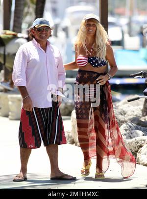 EXCLUSIVE!! Ruta Maria Teresa wears a patriotic stars and stripes bikini and wrap as she strolls and takes a bike ride with husband Roberto Zappulla at the South Beach Marina. Miami Beach, FL. 5th May 2014. Stock Photo