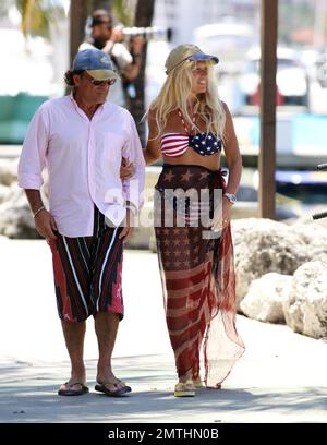 EXCLUSIVE!! Ruta Maria Teresa wears a patriotic stars and stripes bikini and wrap as she strolls and takes a bike ride with husband Roberto Zappulla at the South Beach Marina. Miami Beach, FL. 5th May 2014. Stock Photo