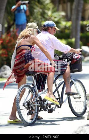 EXCLUSIVE!! Ruta Maria Teresa wears a patriotic stars and stripes bikini and wrap as she strolls and takes a bike ride with husband Roberto Zappulla at the South Beach Marina. Miami Beach, FL. 5th May 2014. Stock Photo