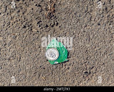 a flattened can of Sprite on a asphalt road Stock Photo