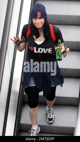 EXCLUSIVE!! Comedian Sarah Silverman wears an 'I Heart Love' t shirt as she leaves a local gym. Silverman carried along her iPhone and a bottled beverage as she headed down an escalator. West Hollywood, CA. 4/20/11. Stock Photo