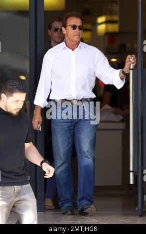 Wearing a western-styled outfit complete with green crocodile cowboy boots, Arnold Schwarzenegger joins daughter Christina for some shopping at Barney's New York in Los Angeles, CA. 8/8/11. Stock Photo